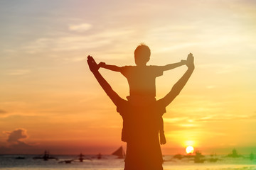 Fototapeta na wymiar happy father and son on sunset beach