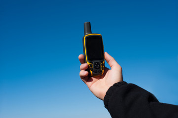 Male hand holding GPS