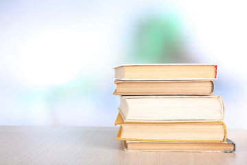Books on wooden table on natural background