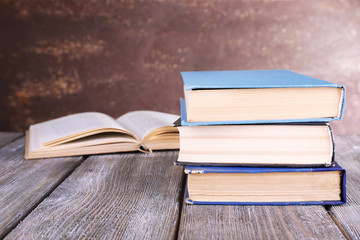 Books on wooden table on dark background