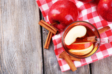 Apple cider with cinnamon sticks and fresh apples