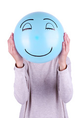 Woman holding balloon in front of her face