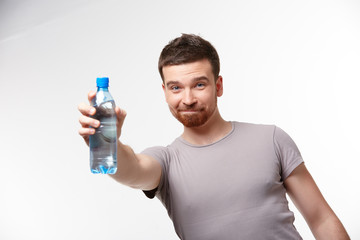 man in jeans and a T-shirt with bottle of water