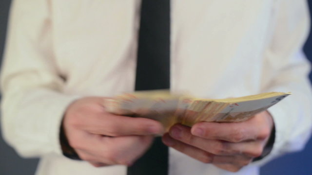 Businessman counting 50 euro banknotes money