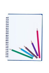 blank notebook with metal spiral and two crayons