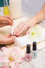 Obraz na płótnie Canvas Nail technician giving customer a manicure