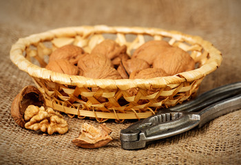 Whole and chopped walnuts on sacking