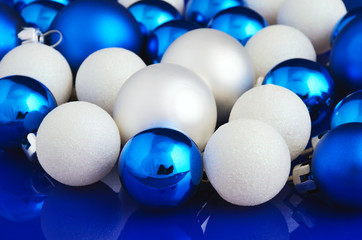 white and blue Christmas balls on blue background