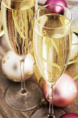 tinted image two glasses with champagne and Christmas tree decor