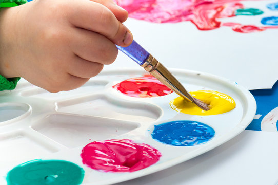 Child Painting With Brush