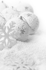 Christmas ornaments on white snowy background