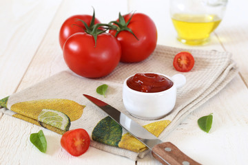 Ripe tomatoes, tomato ketchup and olive oil