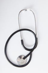 Black Stethoscope on white glossy table