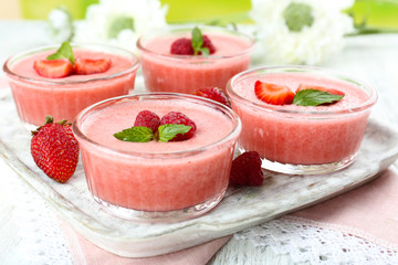 Delicious berry mousse in bowls on table close-up