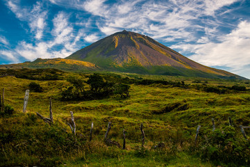 Evening sun gracing Pico on the island of Pico-Azores-Portugal. - obrazy, fototapety, plakaty