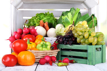 Vegetables in crate and in basket on white wooden box - Powered by Adobe