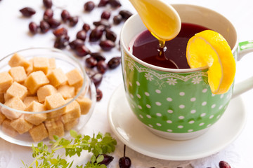 Cup of hip roses tea with lemon and honey