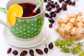 Cup of hip roses tea with lemon and brown sugar