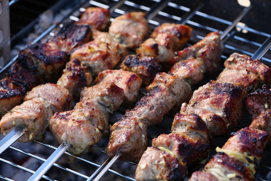 Skewers on barbecue grill, close-up