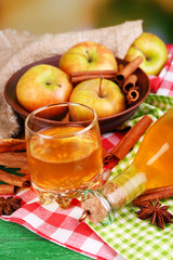 Composition of apple cider with cinnamon sticks, fresh apples