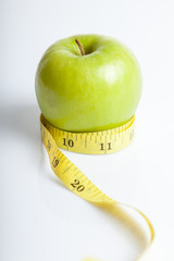 Measuring tape with green apple
