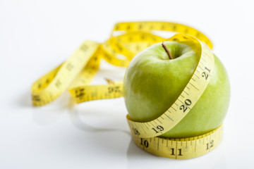 Measuring tape with green apple