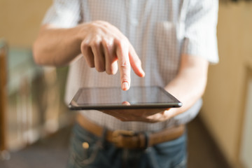 Man hand touching screen on modern digital tablet pc