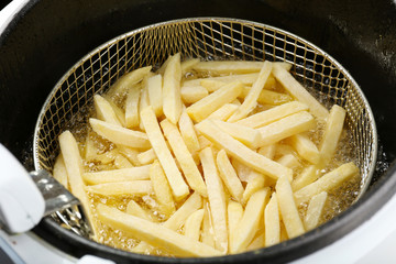 French fries in deep fryer, closeup