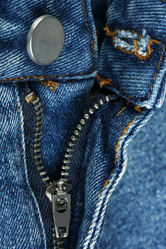 Zipper and button on clothes close up