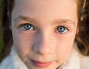 Cute little girl with honest blue eyes