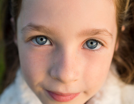 Cute little girl with honest blue eyes