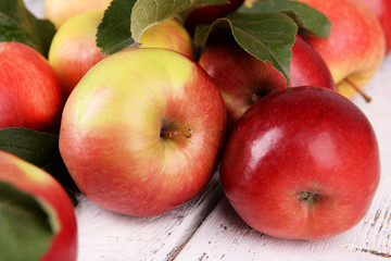 Ripe red apples on wooden background