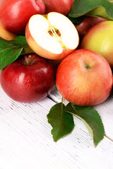 Ripe red apples on wooden background