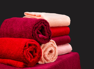 stack of colorful terry towels on a table