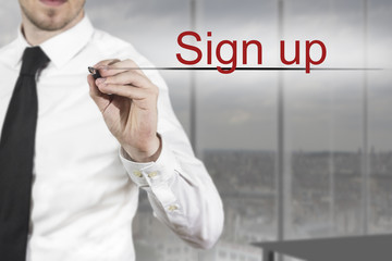 businessman writing in the air sign up