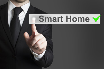 businessman pushing flat button smart home