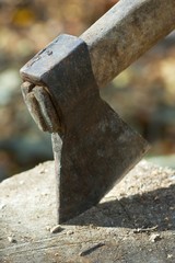 Old axe stuck in block of wood