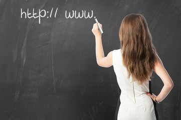 Woman writing URL on blackboard. - obrazy, fototapety, plakaty