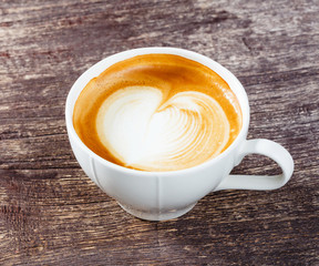Cup of coffee on old wooden table