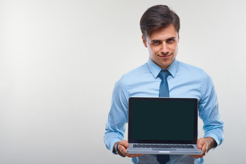 Business man holding a laptop against a white background