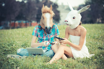 mask horse and rabbit women sisters friends using smartphone and