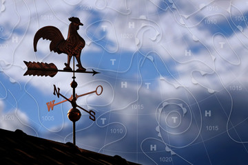 Weathercock with weather map in background