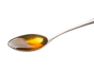 A spoon of honey over white background - 71545762