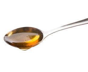 A spoon of honey over white background - 71545766