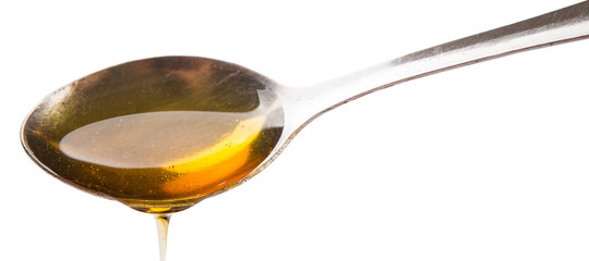 A spoon of honey over white background - 71545786