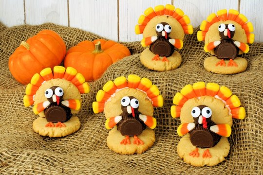 Thanksgiving turkey shaped cookies on burlap with pumpkins