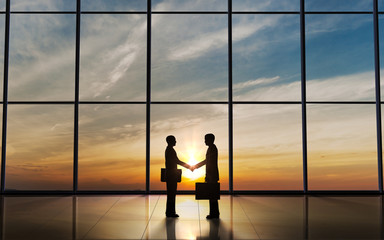 Fototapeta premium Two Business shake hand silhouettes