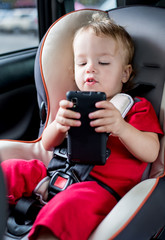 toddler boy playing smartphone