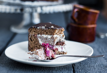 eating chocolate cake with butter cream and cherries, birthday