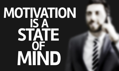 Business man with the text Motivation Is A State of Mind
